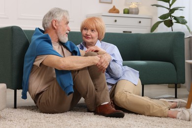 Photo of Lovely senior couple together on floor at home