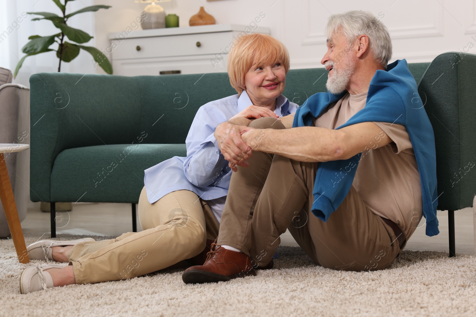 Lovely senior couple together on floor at home Photo of Lovely senior couple together on floor at home