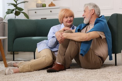 Photo of Lovely senior couple together on floor at home