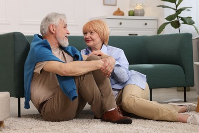 Photo of Lovely senior couple together on floor at home
