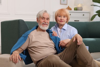 Photo of Lovely senior couple together on floor at home