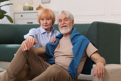 Photo of Lovely senior couple together on floor at home