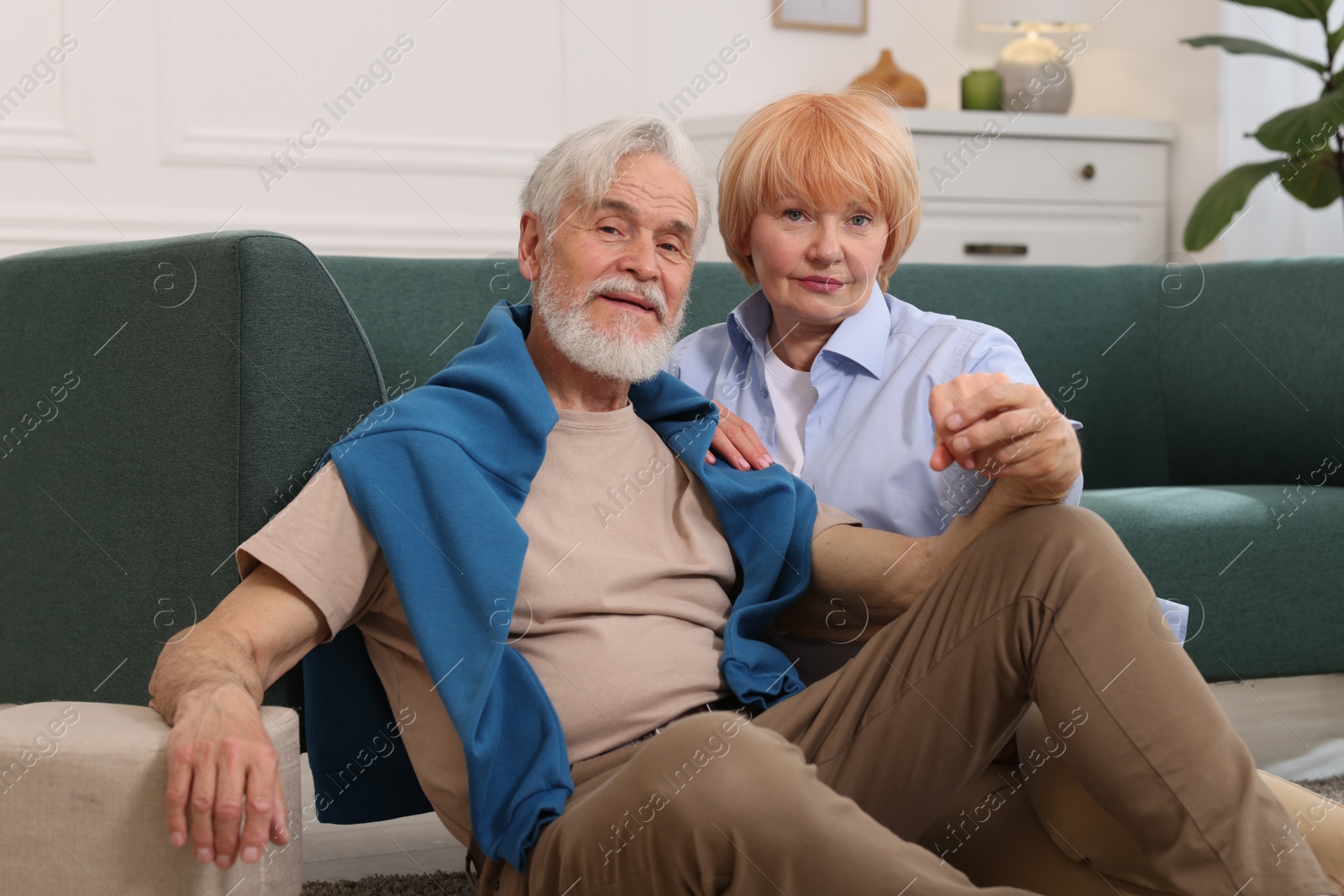 Lovely senior couple together on floor at home Photo of Lovely senior couple together on floor at home