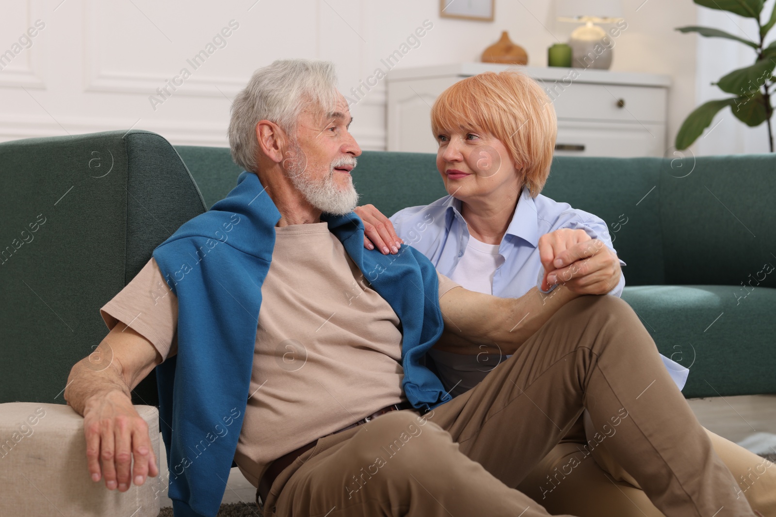 Lovely senior couple together on floor at home Photo of Lovely senior couple together on floor at home