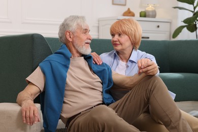 Photo of Lovely senior couple together on floor at home
