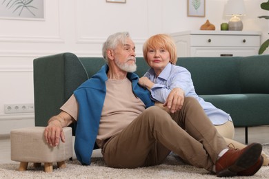 Photo of Lovely senior couple together on floor at home