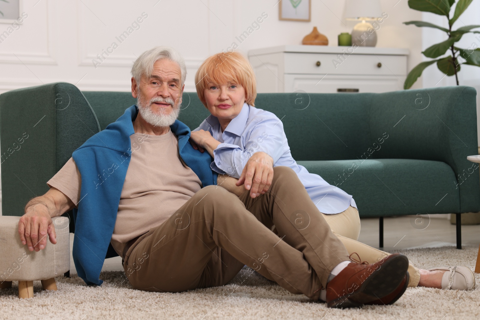 Lovely senior couple together on floor at home Photo of Lovely senior couple together on floor at home