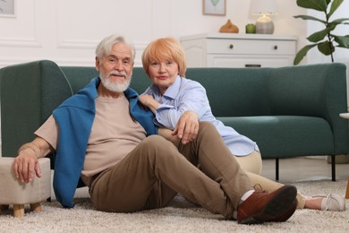 Photo of Lovely senior couple together on floor at home