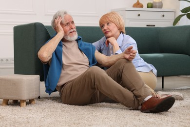 Photo of Lovely senior couple together on floor at home