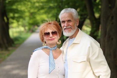 Photo of Lovely senior couple spending time together in park