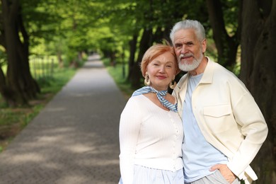 Photo of Lovely senior couple together in park, space for text