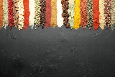 Photo of Many different spices on black table, flat lay. Space for text