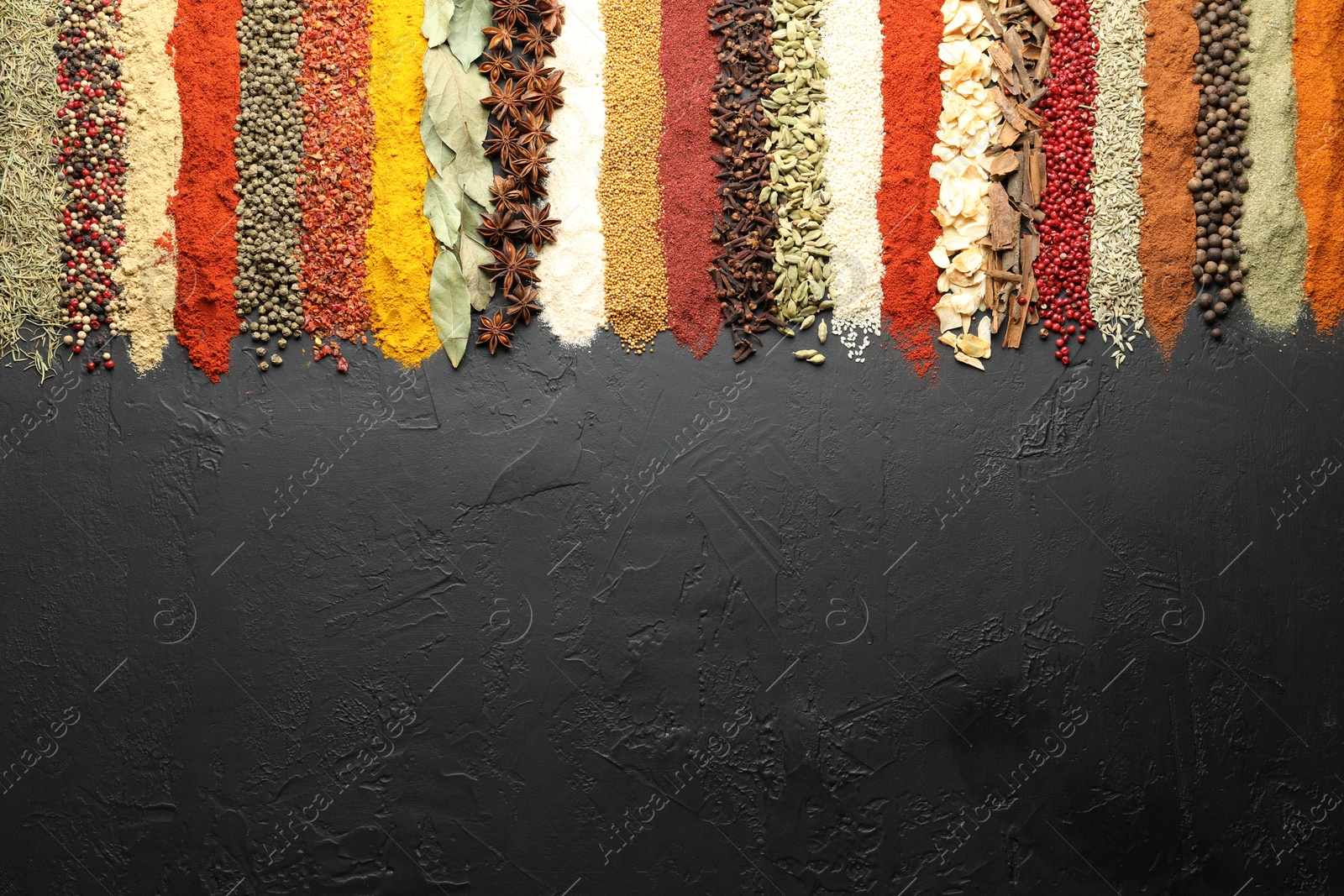 Many different spices on black table, flat lay. Space for text Photo of Many different spices on black table, flat lay. Space for text