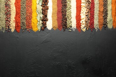 Photo of Many different spices on black table, flat lay. Space for text