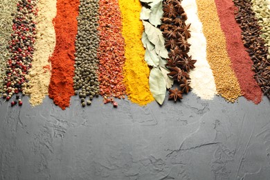 Photo of Many different spices on black table, closeup. Space for text