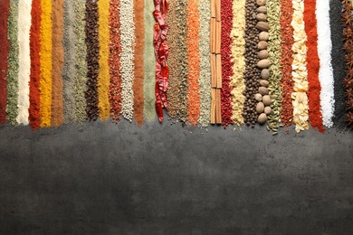 Photo of Many different spices on black table, flat lay. Space for text