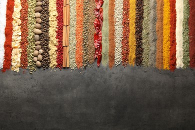 Photo of Many different spices on black table, flat lay. Space for text