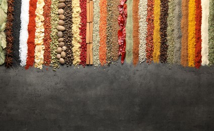 Photo of Many different spices on black table, flat lay. Space for text
