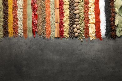Photo of Many different spices on black table, flat lay. Space for text