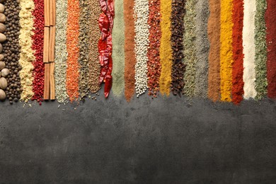 Photo of Many different spices on black table, flat lay. Space for text