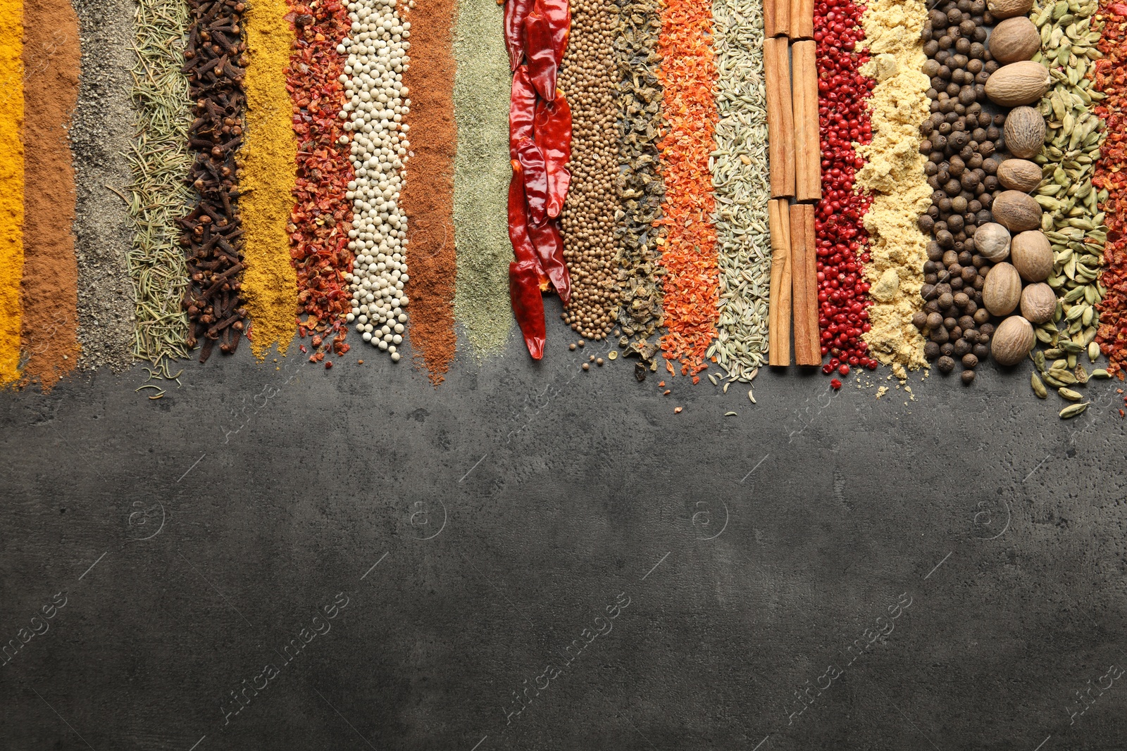 Many different spices on black table, flat lay. Space for text Photo of Many different spices on black table, flat lay. Space for text