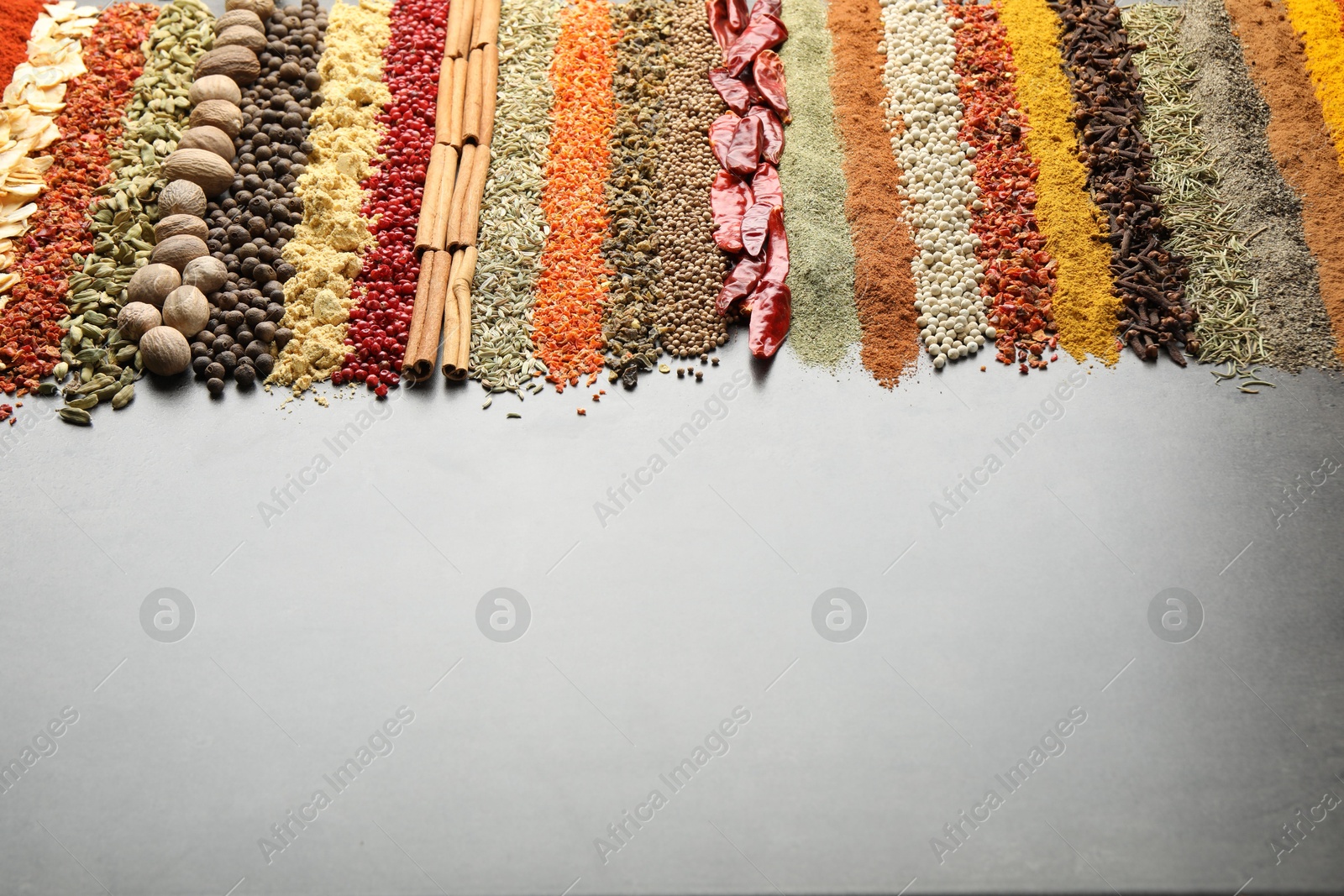 Many different spices on black table, closeup. Space for text Photo of Many different spices on black table, closeup. Space for text