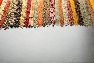 Photo of Many different spices on black table, closeup. Space for text