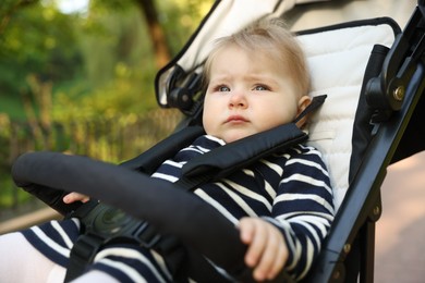 Photo of Cute little baby in stroller at park