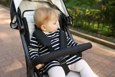 Photo of Cute little baby in stroller at park