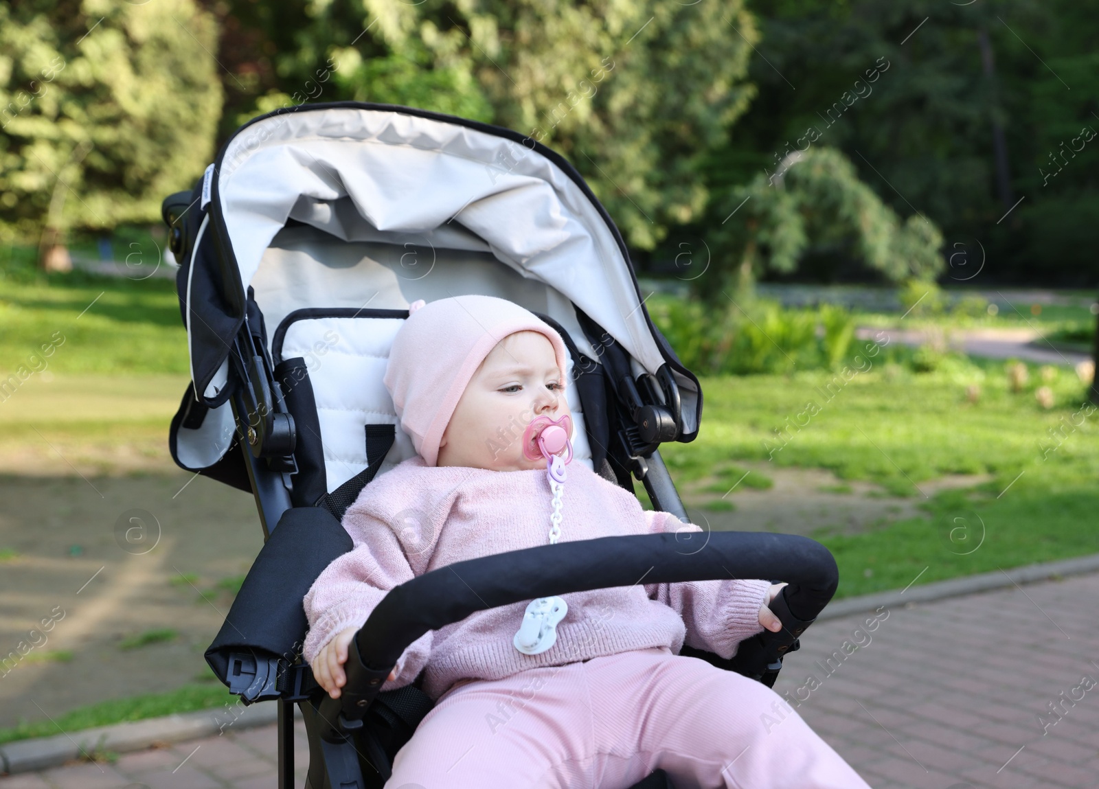 Cute little baby in stroller at park Photo of Cute little baby in stroller at park