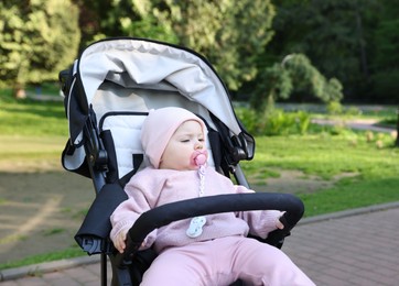 Photo of Cute little baby in stroller at park