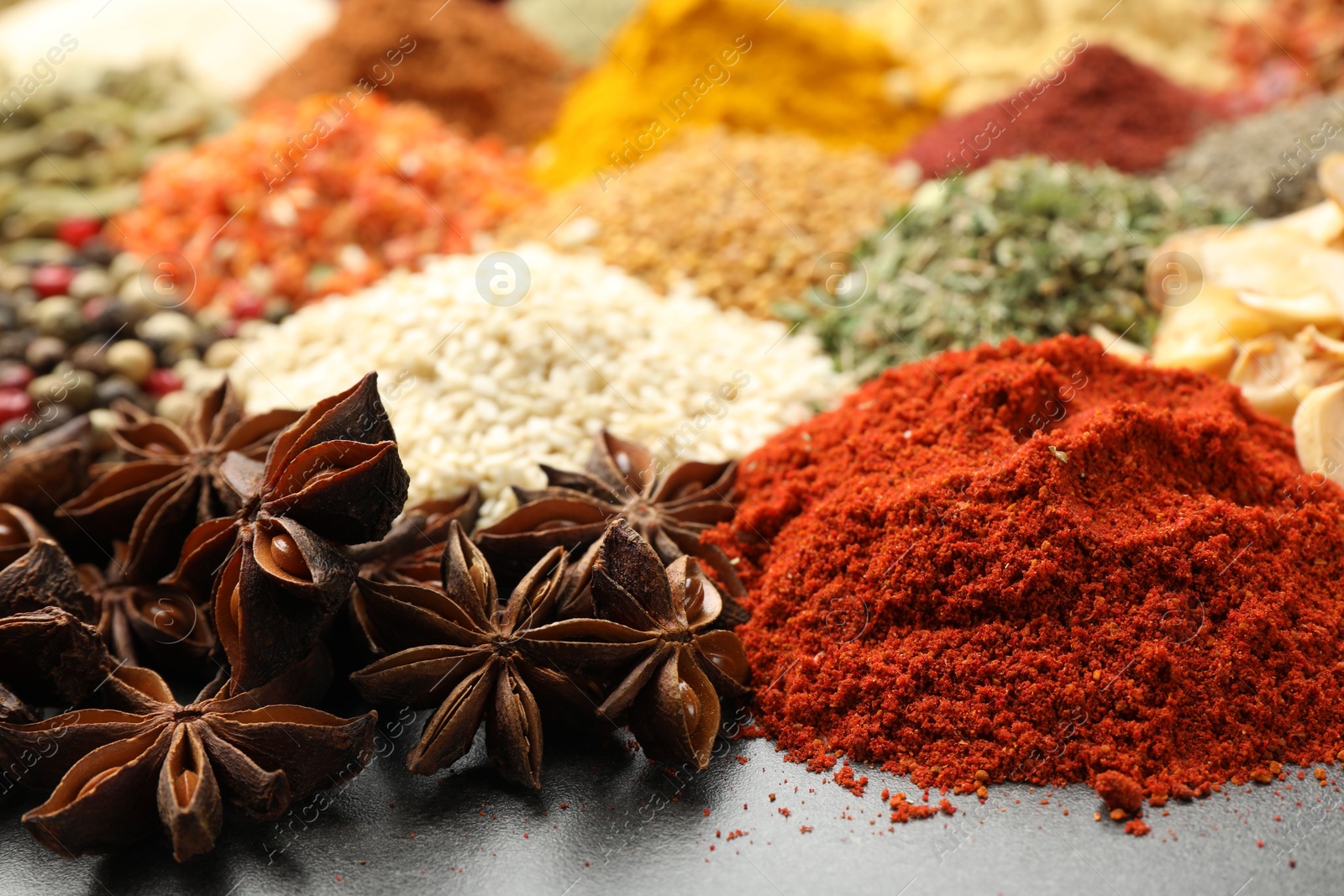 Different aromatic spices on grey table, closeup Photo of Different aromatic spices on grey table, closeup