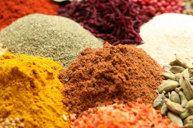 Photo of Different aromatic spices as background, closeup view