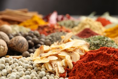 Photo of Different aromatic spices on table, closeup view