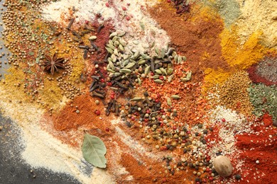 Photo of Different aromatic spices on grey table, top view