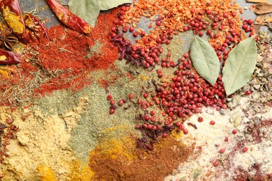 Photo of Different aromatic spices on grey table, top view