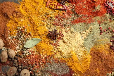 Photo of Different aromatic spices as background, top view
