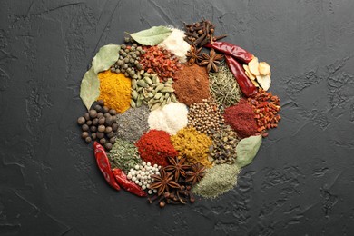 Photo of Different aromatic spices on grey table, top view