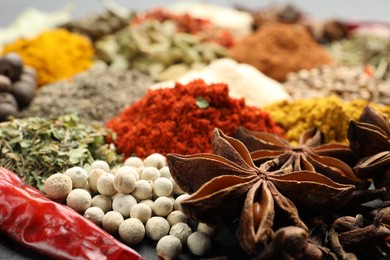 Photo of Different aromatic spices as background, closeup view