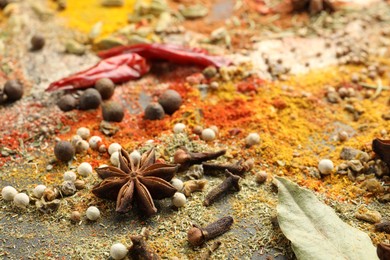 Photo of Different aromatic spices as background, closeup view