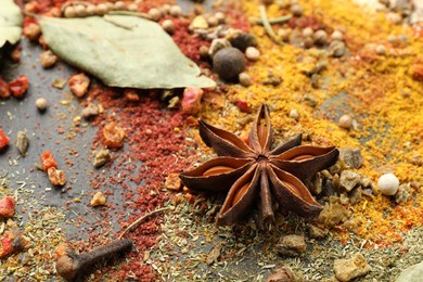 Photo of Different aromatic spices on grey table, closeup