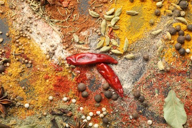 Photo of Different aromatic spices on grey table, top view