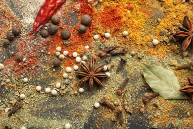 Photo of Different aromatic spices on grey table, top view
