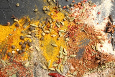 Photo of Different aromatic spices on grey table, top view