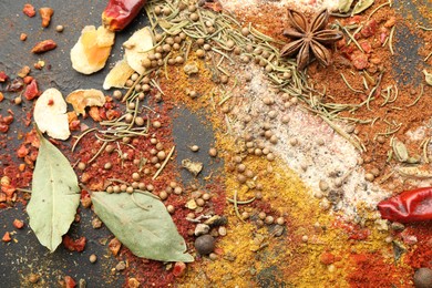 Photo of Different aromatic spices on grey table, top view