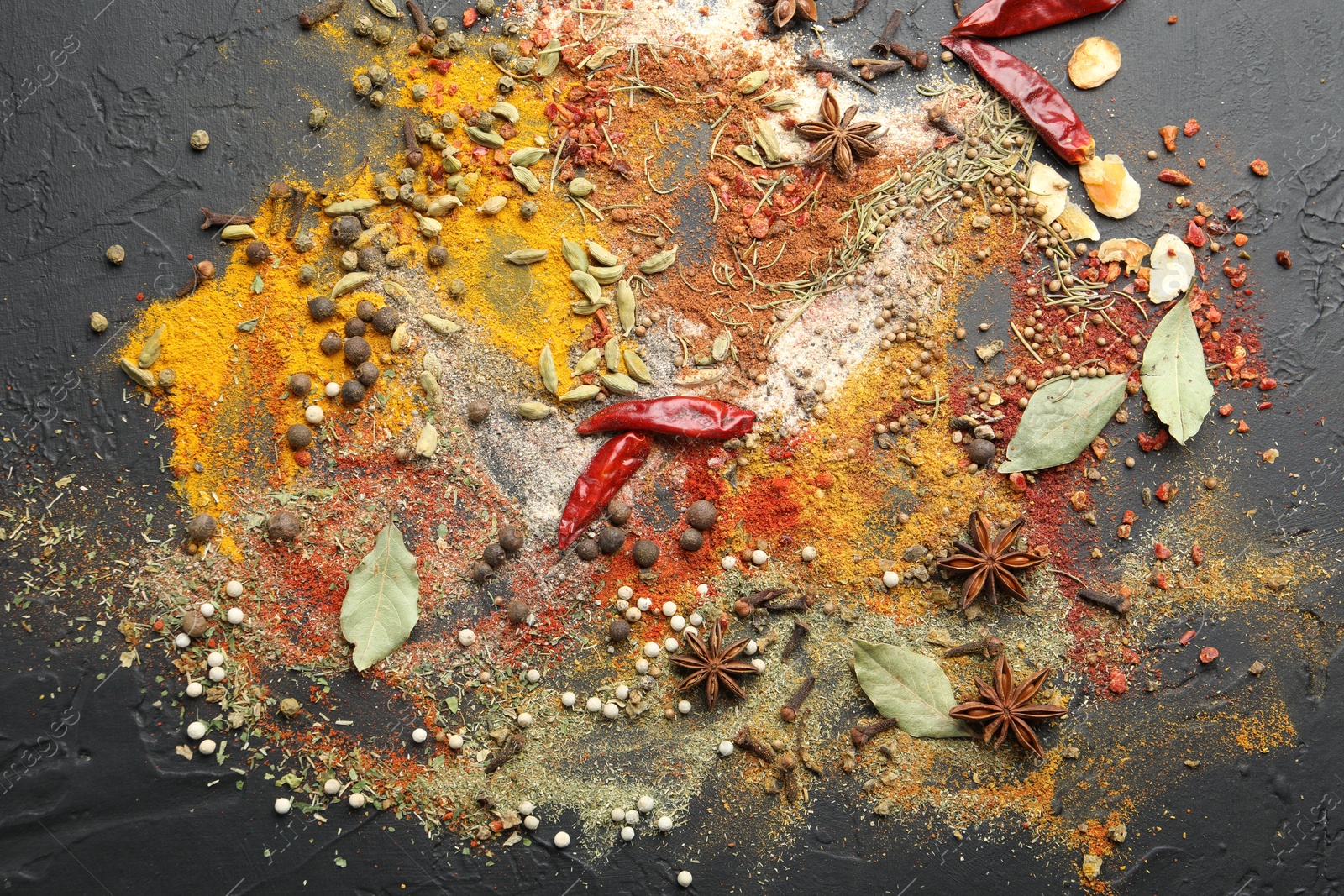 Different aromatic spices on grey table, top view Photo of Different aromatic spices on grey table, top view