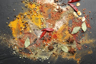 Photo of Different aromatic spices on grey table, top view