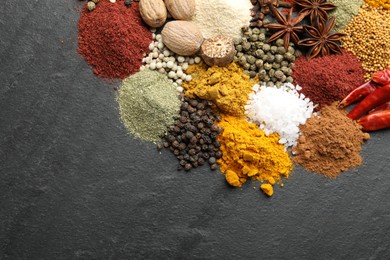 Photo of Different aromatic spices on grey table, top view. Space for text