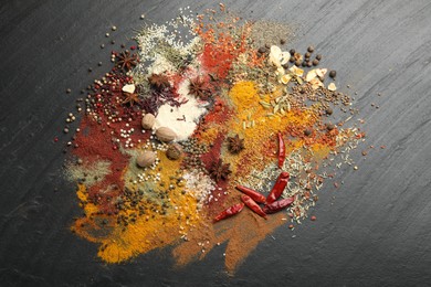 Photo of Different aromatic spices on grey table, top view