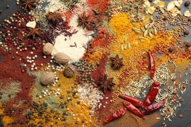 Photo of Different aromatic spices on grey table, top view